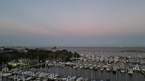 Camera rises over a boat filled marina at dusk Stock Footage 337072726