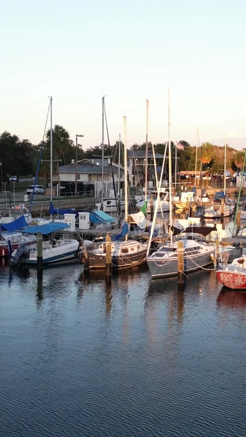Camera rises over a boat filled marina to reveal the ocean beyond Stock Footage 337120453