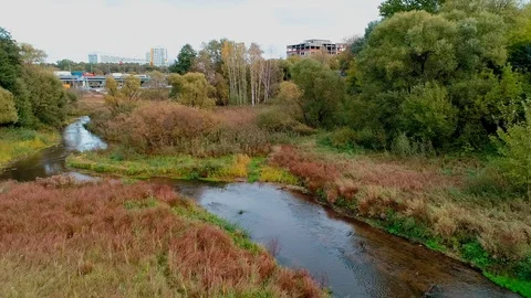 The camera rises over a small river and the temple becomes visible. Stock Footage 99856842