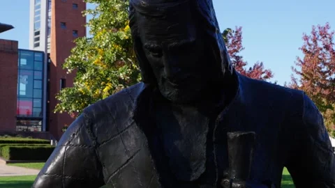 Camera rises up statue of Shakespeare in Stratford upon Avon Stock Footage 325774424
