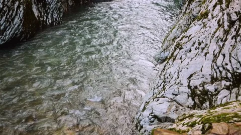 Camera rises from  stream of water into  distance of  gorge 스톡 동영상 84735327