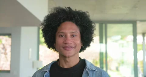 With camera rolling, African American man standing in living area smiling then Stock Footage 335514160