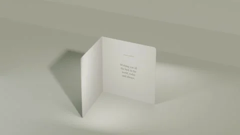 Camera rolling, card rotating and opening on studio table, revealing Good Luck Stock Footage 339721872