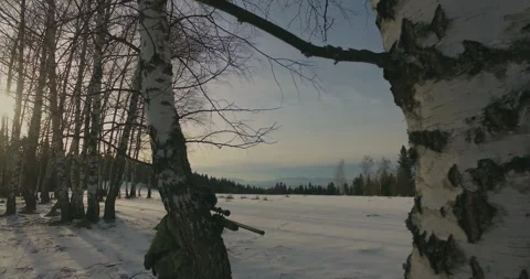 Camera Rotate tree reveal kneeling sniper Stock Footage 151704811