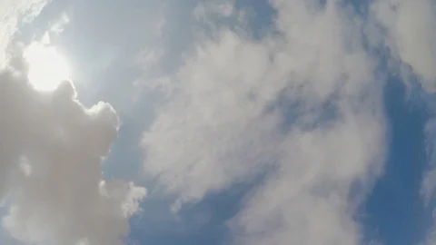 Camera rotated under white fluffy clouds in the sky Stock Footage 124861164