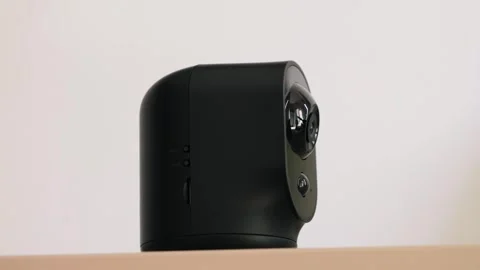 The camera rotates and reacts to movements. Wireless IP camera that monitors the Stock Footage 330195228
