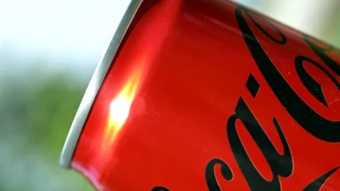 The camera rotates around the red cans of Coca-Cola ZERO Stock Footage 195111025