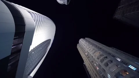 Camera rotates in circle with view of tall skyscrapers at night Stock Footage 191528691