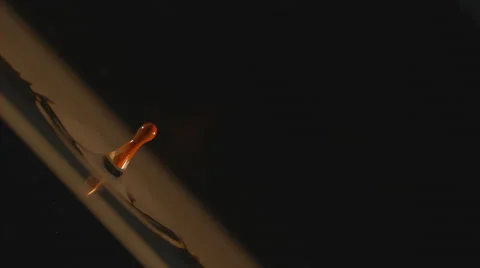 Camera rotates close up as orange paint drop falls to water surface, splashing Stock Footage 63852269