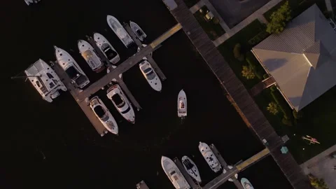 Camera Rotates in Sync with Boat as it Pulls into Dock at Sunset Stock Footage 201499617