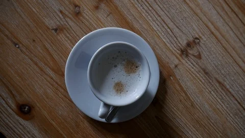 Camera rotating around coffee cup on wooden table 스톡 동영상 112160297
