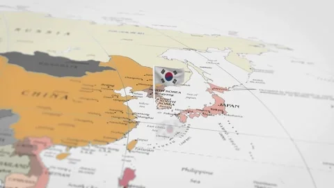 The camera rotating around South Korea on the world map takes the focus. Video stock 299940945