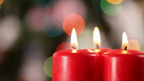 Camera rotating in front of three xmas candles Video stock 81229152