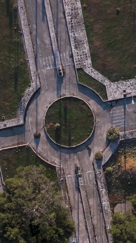 Camera rotating over empty roundabout with trees Stock Footage 290451020