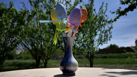 Camera rotation around decorative Easter eggs in a vase against the backdrop of Stock Footage 233151950