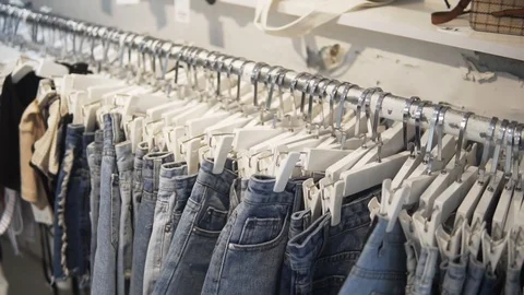 Camera run across a rack of clothes, browsing in a boutique. Head-on view with 動画素材 92143592