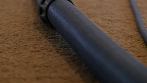 Camera running the length of a hose for a carpet cleaner in home Stock-Footage 85866860