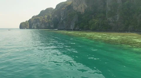 Camera runs along fast the mountains overlooking the sea on the water surface.N. Stock Footage 63752248