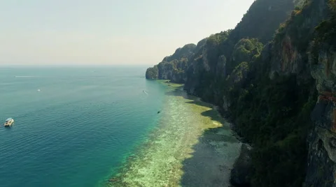 The camera runs along the mountains overlooking the sea. Aerial drone video. N. Stock Footage 63653936