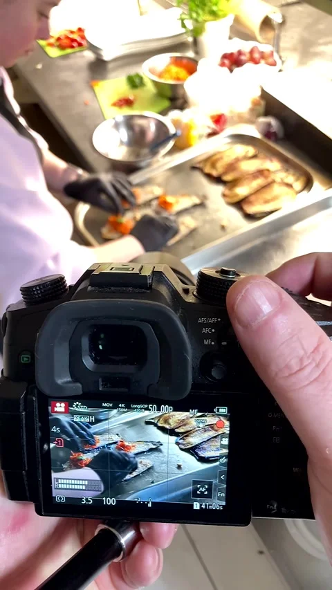 Camera screen captures a chef&amp;#039;s hands preparing eggplant rolls Stock Footage 331710380