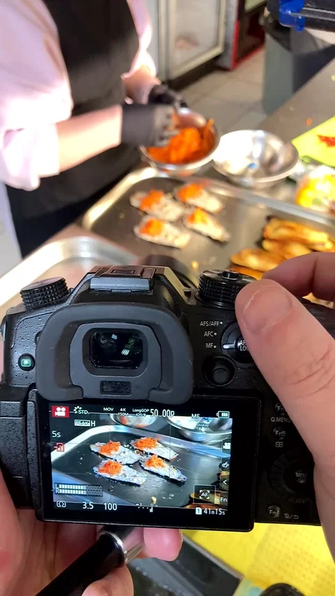 Camera screen captures a chef&amp;#039;s hands preparing eggplant rolls Stock-Footage 331710397