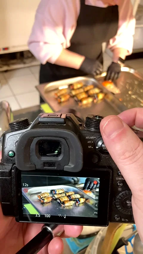 Camera screen captures a chef&amp;#039;s hands preparing eggplant rolls Stock Footage 331710433