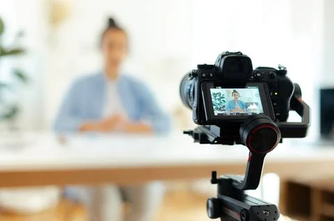 On a camera screen pretty indian or arabian brunette young woman, blogger Stock Photos