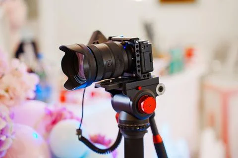 Camera set on tripod with colorful background at event location Stock Photos