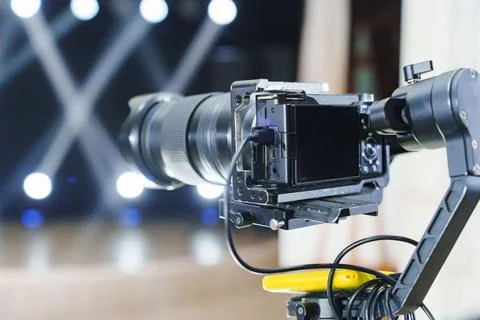 Camera set up for video recording during an event with bright background lights Stock Photos