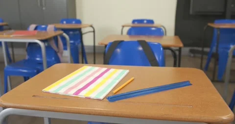 Camera is shifting and refocusing near classroom desk to highlight pastel Stock Footage 341063984