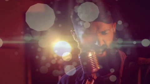 Camera shifting closer, music playing, vocalist singing into mic, bokeh flare Stock Footage 333936763