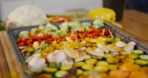 Camera shifting focus and angle to reveal roasting tray holding seasoned Stock Footage 339232466