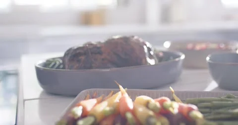 Camera shifting focus bringing asparagus into focus as roast is softening to Stock Footage 337286972