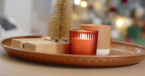 Camera shifting focus is making red ribbed candle flicker and glow on tray, Stock Footage 344404129