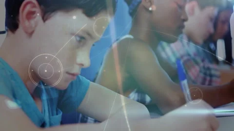 Camera shifting toward boy writing in classroom, overlay linking pens with 스톡 동영상 312694295