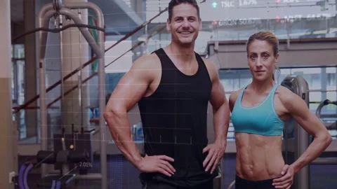 Camera shifting two trainers posing in gym animated charts overlaying trainers Video stock 332566476