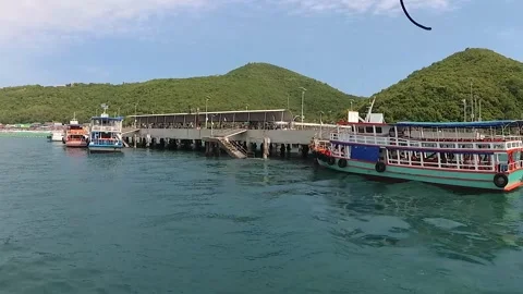The camera ship is sailing past the marina with the big ferries. Video stock 130903797