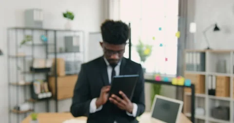 Camera shooting on attractive smiling modern confident skilled bearded black Stock Footage 159718895