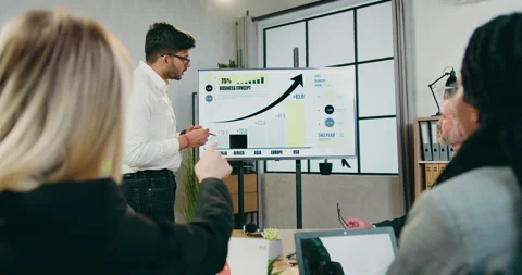 Camera shooting over shoulders of mixed race businesspeople which listening Stock Footage 161033953