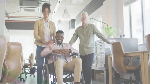 Camera shooting, work team posing, showing unity, man in wheelchair adjusting, Stock Footage 333936635