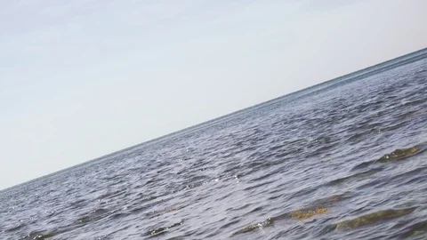 Camera shoots at an angle of the sea landscape shallow waves Stock Footage 80452723