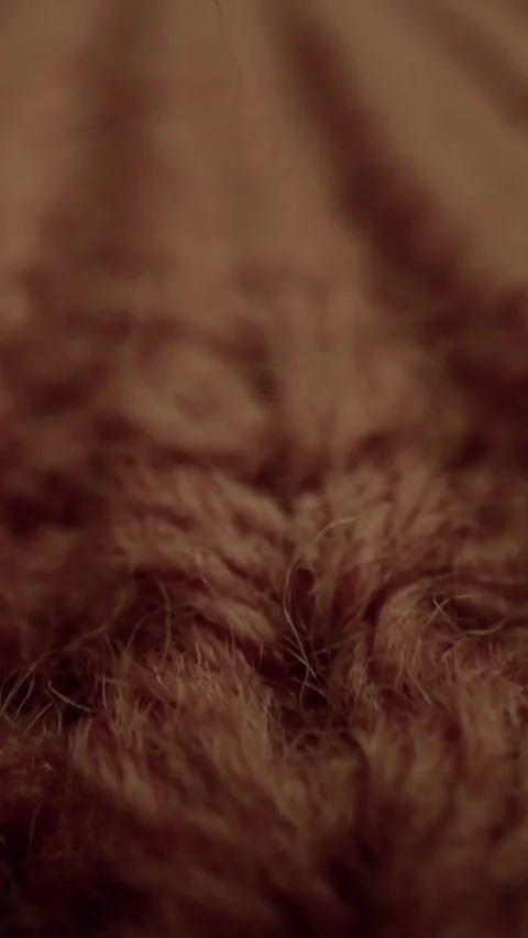 Camera shoots a macro view of the intricate texture of brown fuzzy wool fabric Stock Footage 340670396