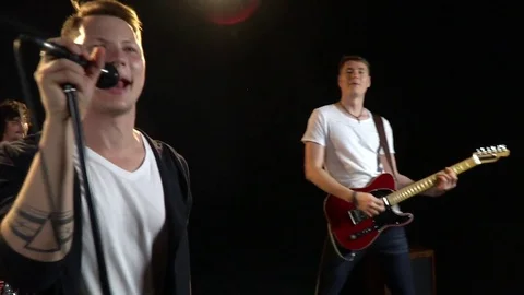 The camera shoots rock musicians in the leaks of light Stock Footage 80647632
