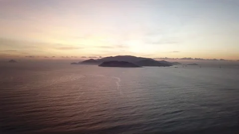 The camera shoots a time lapse of sunrise over an island. Stock Footage 124909900