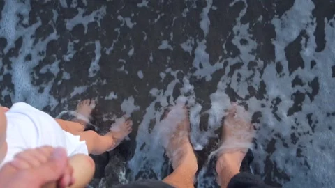 The camera shoots from top to bottom two pairs of bare legs standing at the very Stock Footage 214673214