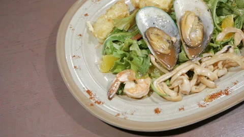 The camera shoots a video of an appetizing seafood salad. Healthy food concept. Stock Footage 109228418