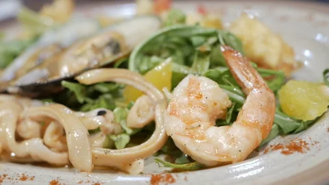The camera shoots a video of an appetizing seafood salad. Healthy food concept. Stock Footage 109228959