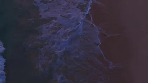 The camera shoots as waves wash the sandy beach at sunset Video stock 71363050