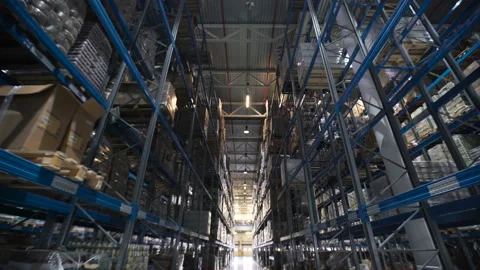 Camera shot of different materials in warehouses racks indoor around: boxes, pal Stock Footage 199490198
