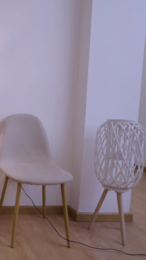 Camera shows chairs and a small table with a lamp Stock Footage 264581600